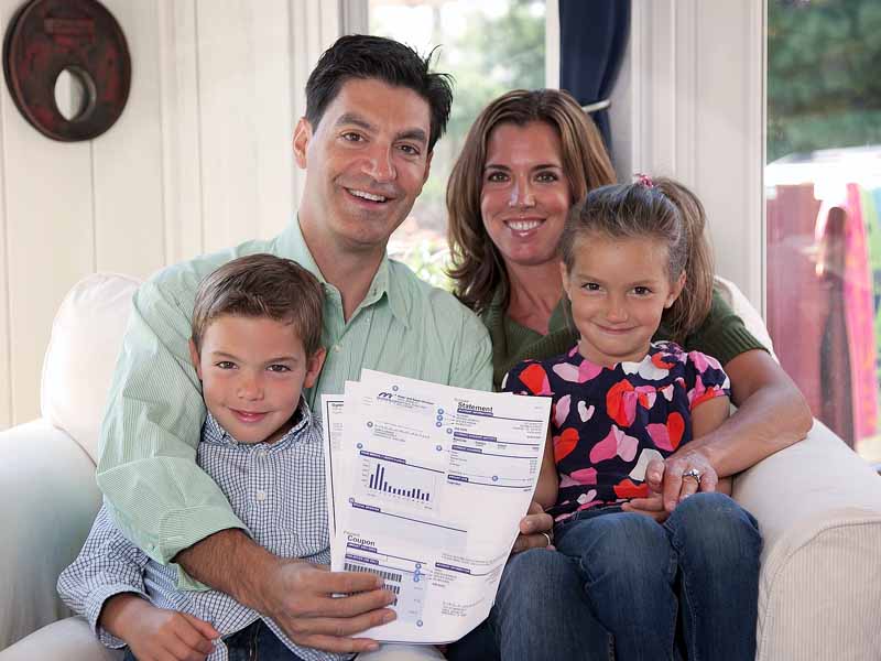 AirGuard 360 - A family holding up utility bills showing savings